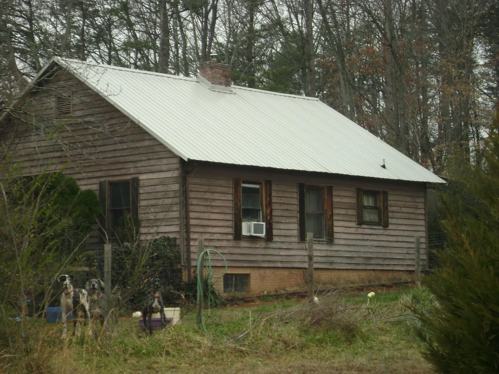 White metal roof on an old wood sided farmhouse, from a Metal Roof Installation job in Loyalhanna